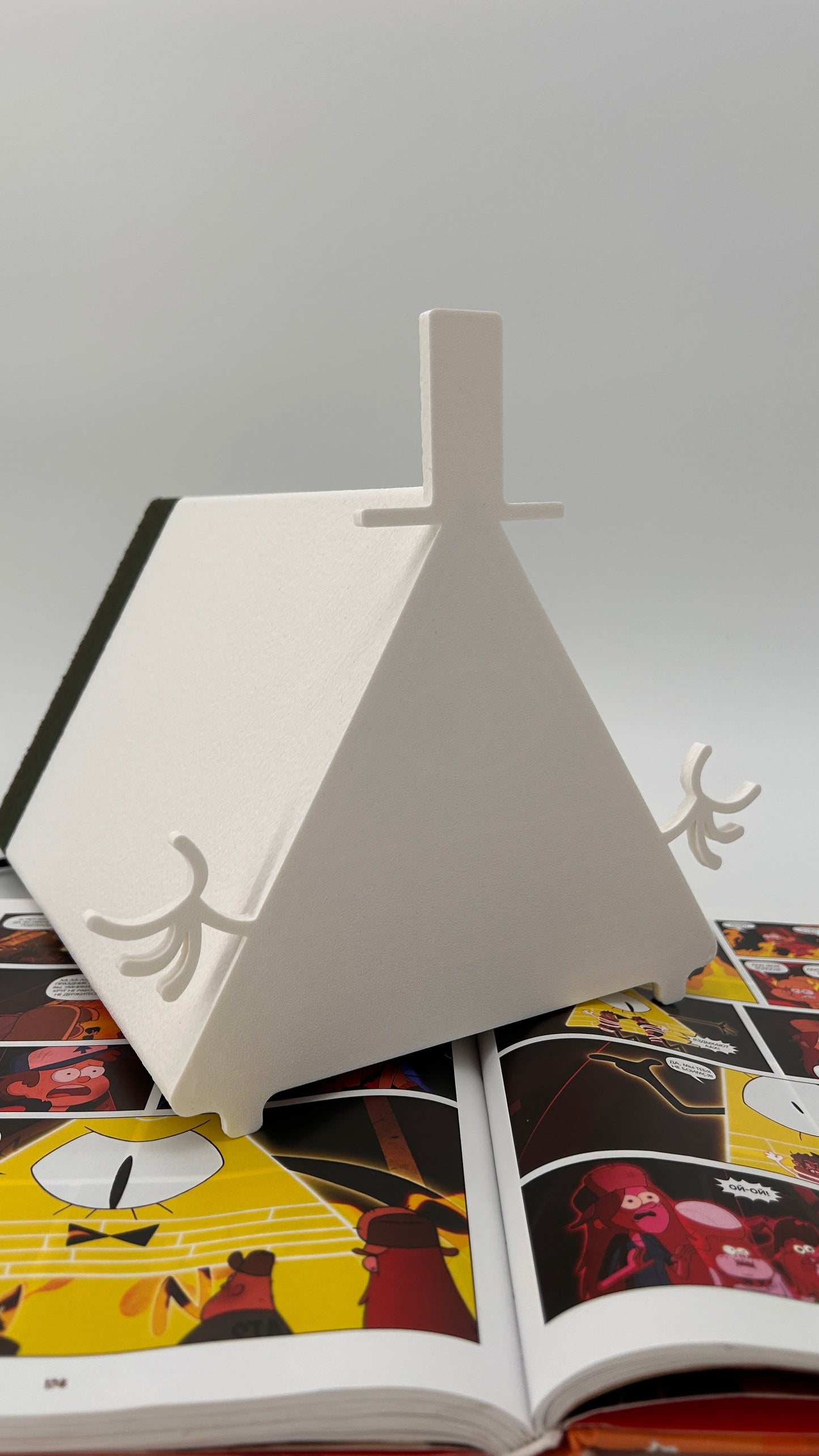 Open book with colorful illustrations on a gray background